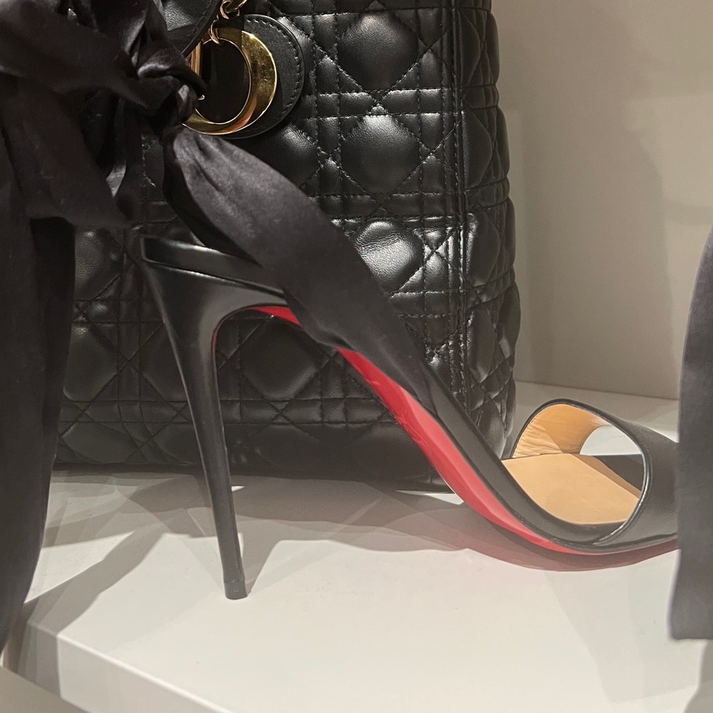 Black Louboutin 100mm heel ribbon tie stilettos.